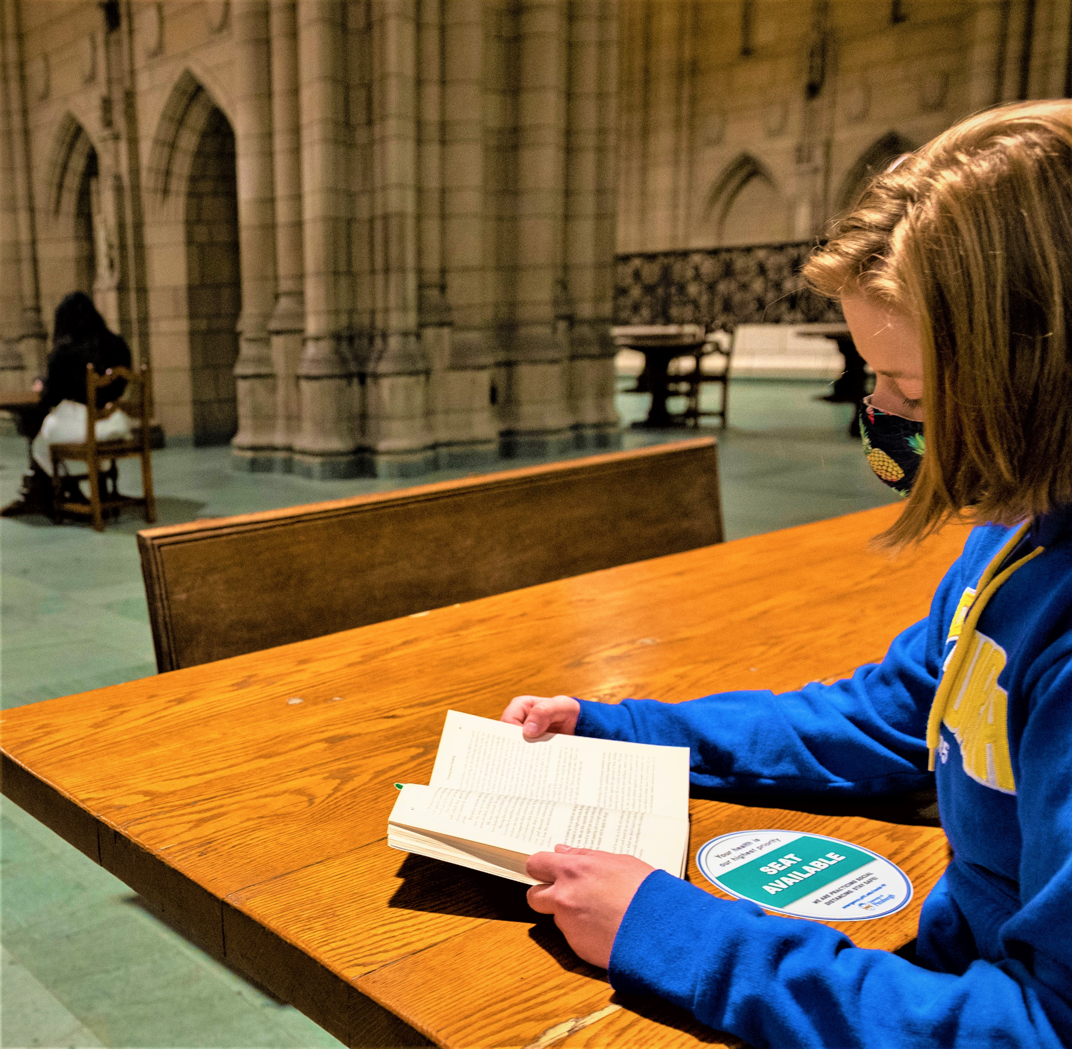 student reading in the Cathedral of Learning