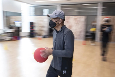 man wearing a mask holding a ball